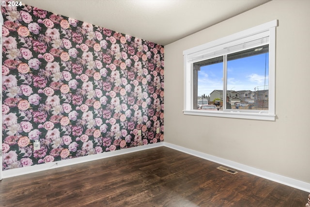 empty room with dark hardwood / wood-style floors