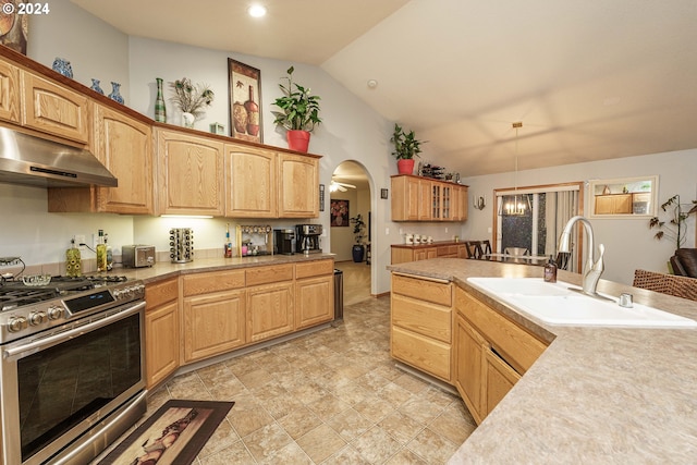 kitchen with stainless steel range with gas cooktop, sink, ceiling fan, and lofted ceiling