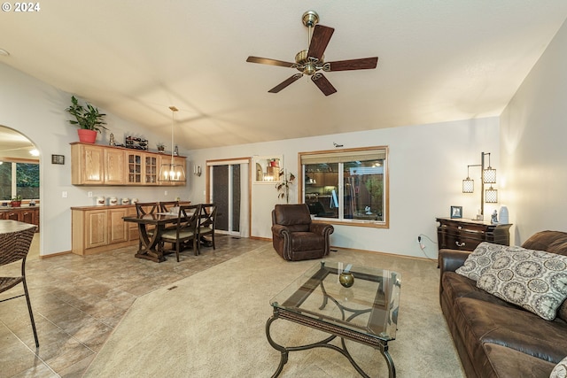 living room with a wealth of natural light, ceiling fan, and lofted ceiling