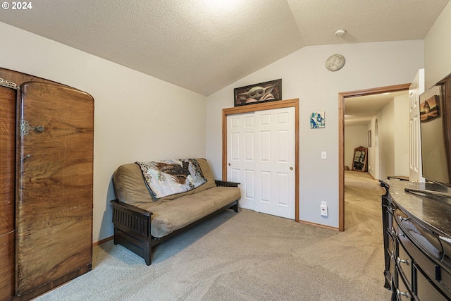 living area featuring a textured ceiling, light colored carpet, and vaulted ceiling