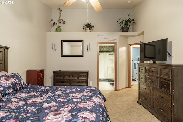 carpeted bedroom featuring a towering ceiling, ceiling fan, connected bathroom, washer / clothes dryer, and a closet