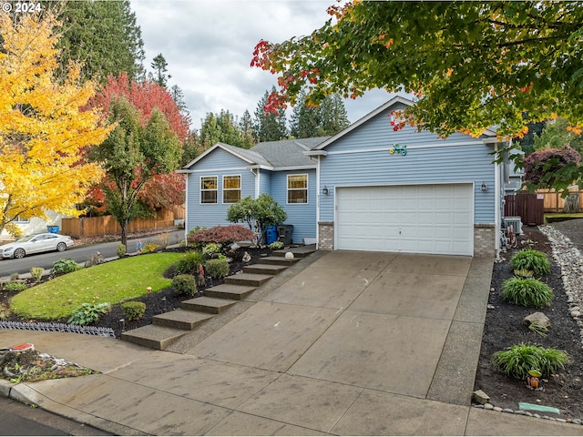 single story home with a garage and a front yard