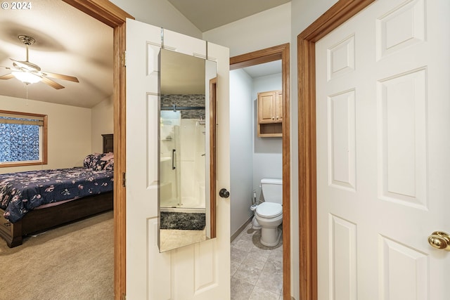 interior space with ceiling fan, light carpet, and connected bathroom