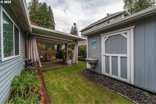 view of yard with a shed and a patio area