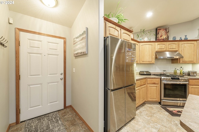 kitchen featuring stainless steel appliances and light brown cabinetry