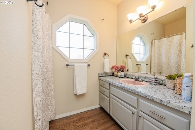 bathroom with large vanity and wood-type flooring