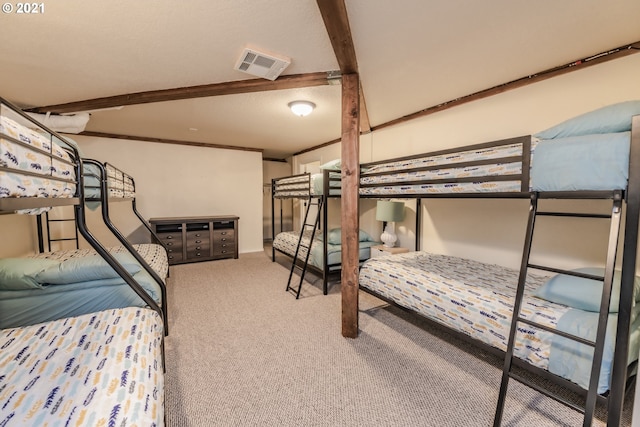 carpeted bedroom featuring beamed ceiling