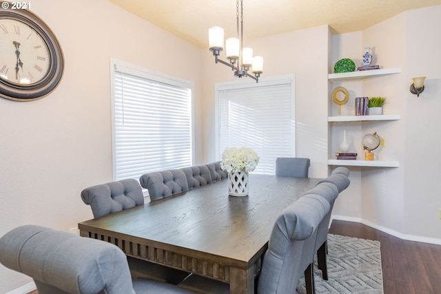 dining area with dark hardwood / wood-style flooring and a chandelier