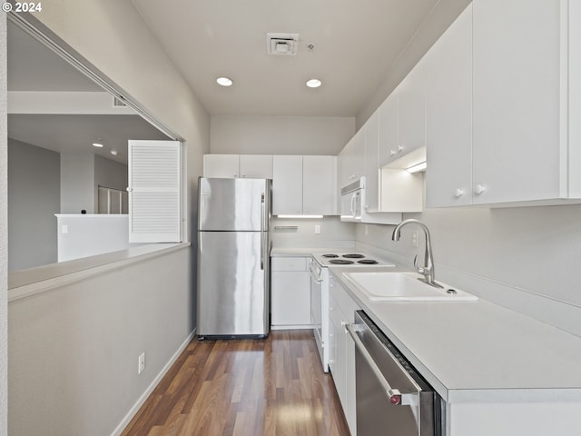 kitchen featuring white cabinetry, sink, appliances with stainless steel finishes, and dark wood-type flooring