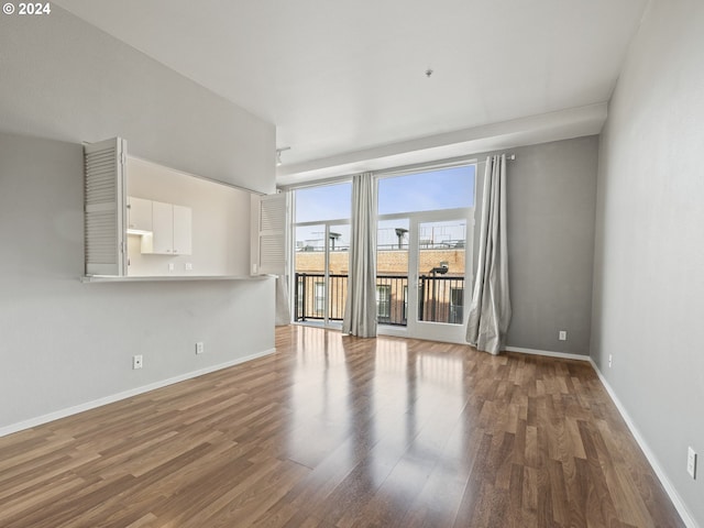 unfurnished room with hardwood / wood-style flooring