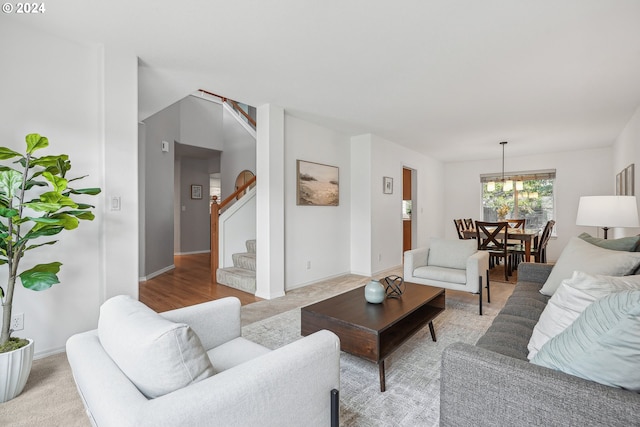 living room featuring a notable chandelier and light hardwood / wood-style flooring