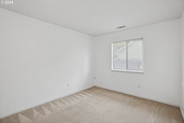 spare room with light colored carpet