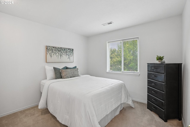 bedroom featuring light carpet