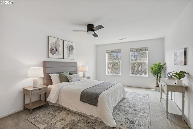 bedroom with ceiling fan and light colored carpet