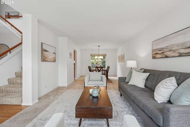 living room featuring light wood-type flooring and an inviting chandelier