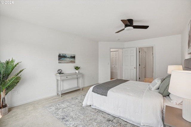 bedroom with ceiling fan and light colored carpet