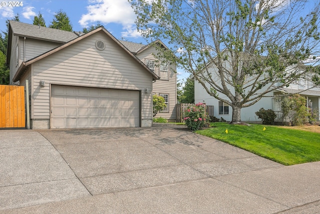 view of front of home with a front lawn and a garage