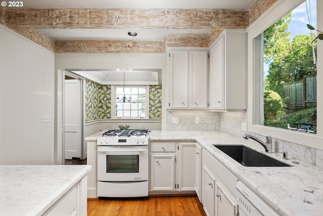 kitchen featuring sink, white cabinetry, light wood-type flooring, white appliances, and light stone countertops