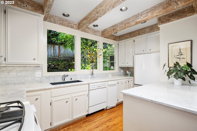 kitchen featuring sink, white appliances, light hardwood / wood-style flooring, white cabinetry, and beam ceiling