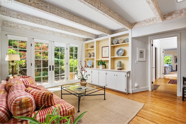 sunroom / solarium with beam ceiling and french doors