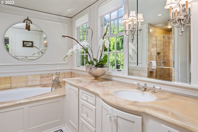 bathroom featuring independent shower and bath, vanity, and a chandelier