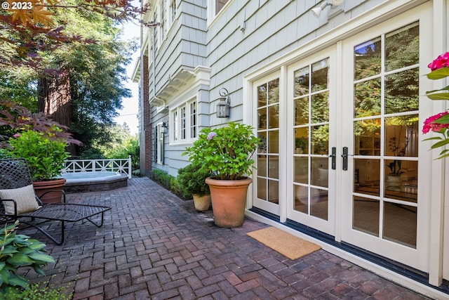 view of patio / terrace featuring french doors and a jacuzzi