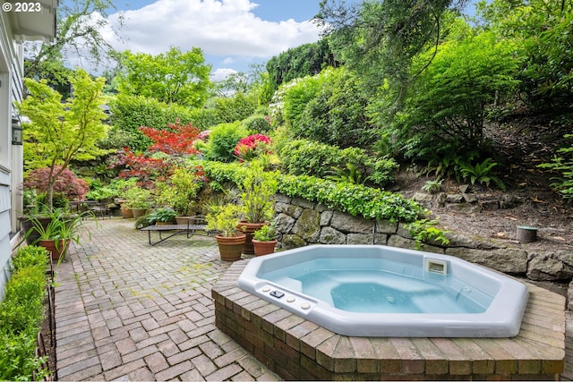 view of swimming pool featuring a patio and an outdoor hot tub