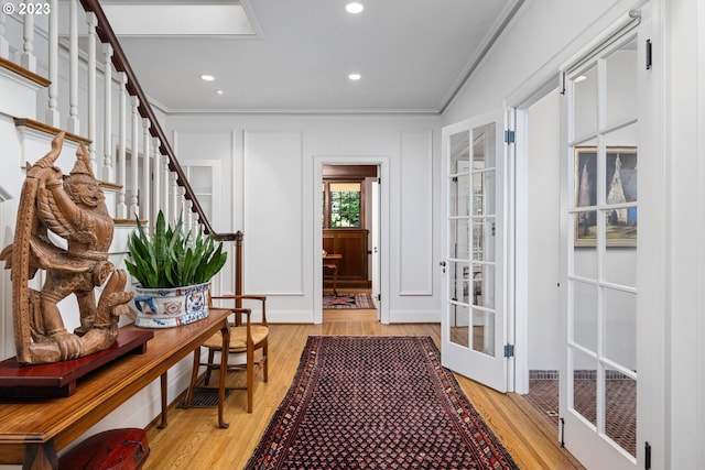 interior space featuring crown molding and light wood-type flooring