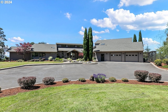 view of front of house with a garage and a front lawn