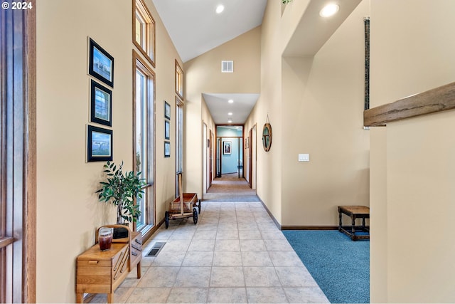 hallway featuring high vaulted ceiling