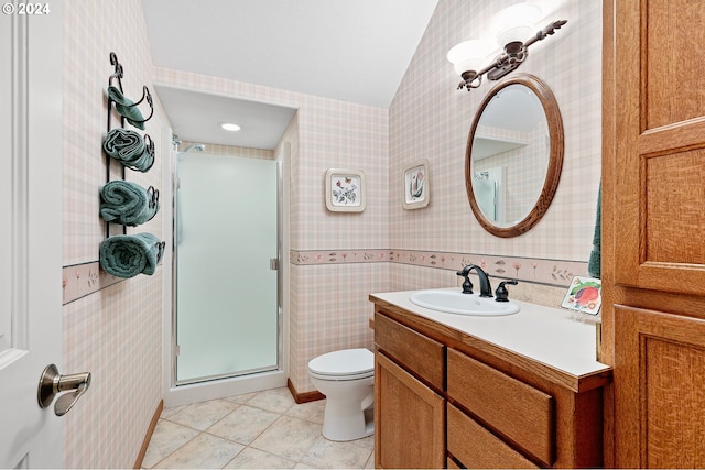 bathroom featuring tile patterned flooring, vanity, toilet, and an enclosed shower