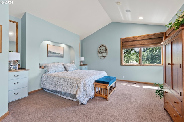 carpeted bedroom with lofted ceiling