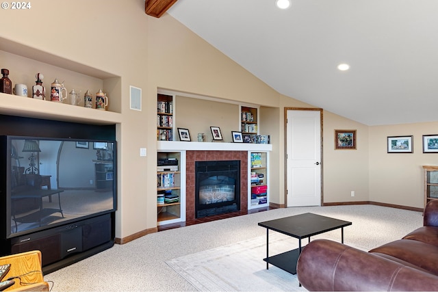 living room featuring carpet flooring, built in shelves, a tiled fireplace, and vaulted ceiling with beams