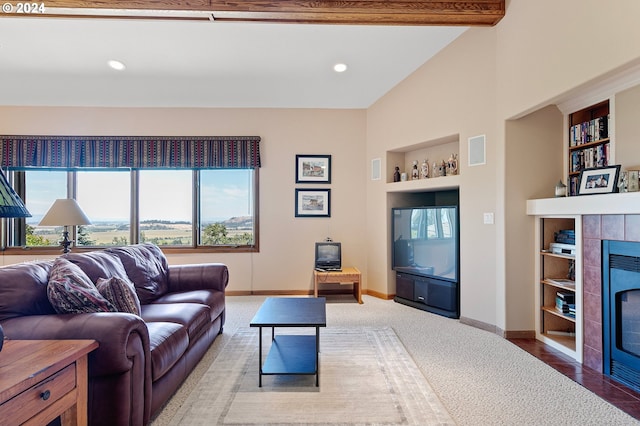 carpeted living room with built in shelves, beam ceiling, and a tiled fireplace