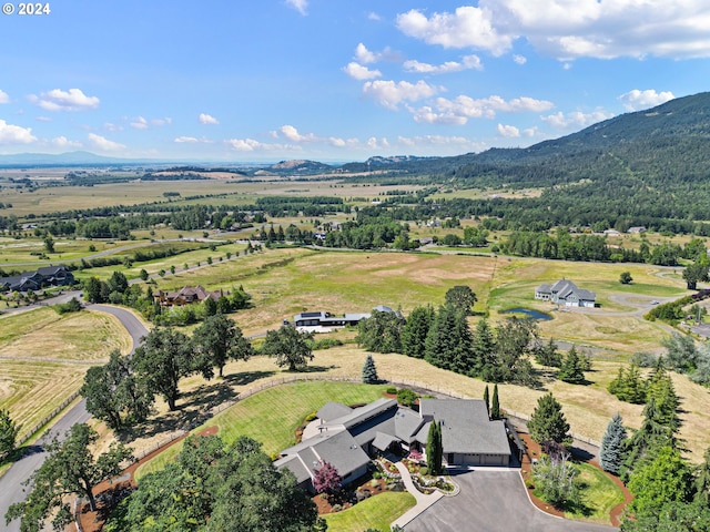 birds eye view of property with a mountain view and a rural view