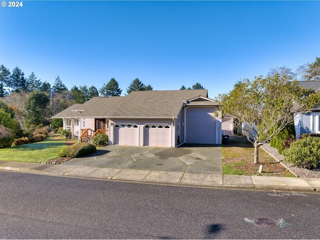 view of front facade with a garage and a front lawn