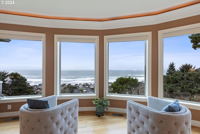 sunroom / solarium with a water view and a healthy amount of sunlight