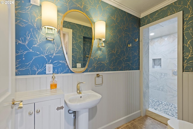 bathroom with ornamental molding and tiled shower