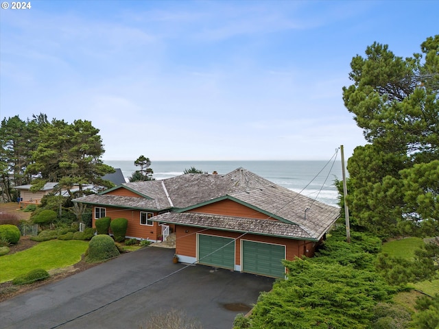 view of front of property with a water view and a garage