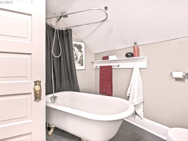 bathroom featuring toilet and lofted ceiling