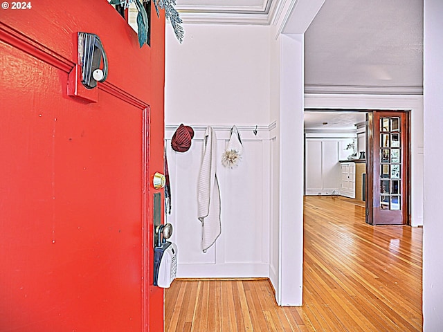 interior space with hardwood / wood-style flooring and ornamental molding