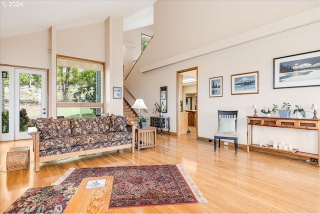 31805 NE Wilsonville Rd, Newberg, OR 97132 - living area with baseboards, stairs, wood finished floors, and high vaulted ceiling