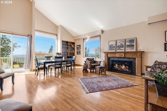 31805 NE Wilsonville Rd, Newberg, OR 97132 - living room featuring a wall unit AC, built in features, a fireplace, wood finished floors, and high vaulted ceiling
