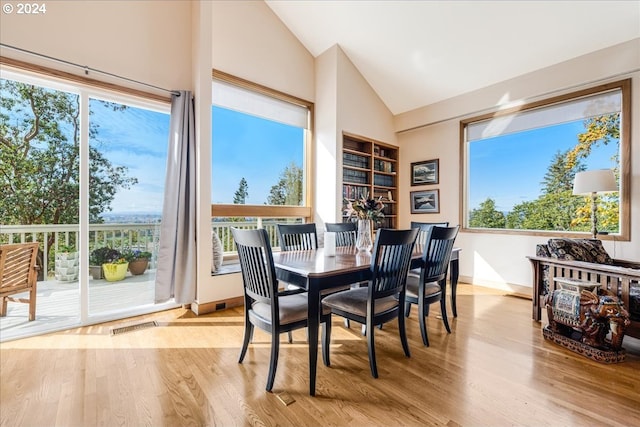 31805 NE Wilsonville Rd, Newberg, OR 97132 - dining space featuring plenty of natural light, built in shelves, wood finished floors, and high vaulted ceiling
