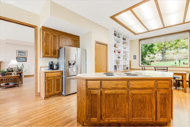 31805 NE Wilsonville Rd, Newberg, OR 97132 - kitchen featuring brown cabinets, white electric stovetop, light countertops, light wood-type flooring, and stainless steel refrigerator with ice dispenser