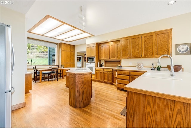 31805 NE Wilsonville Rd, Newberg, OR 97132 - kitchen with a sink, light wood finished floors, a kitchen island, and stainless steel appliances