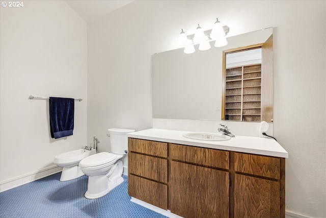 bathroom with vanity, a bidet, toilet, and tile patterned floors