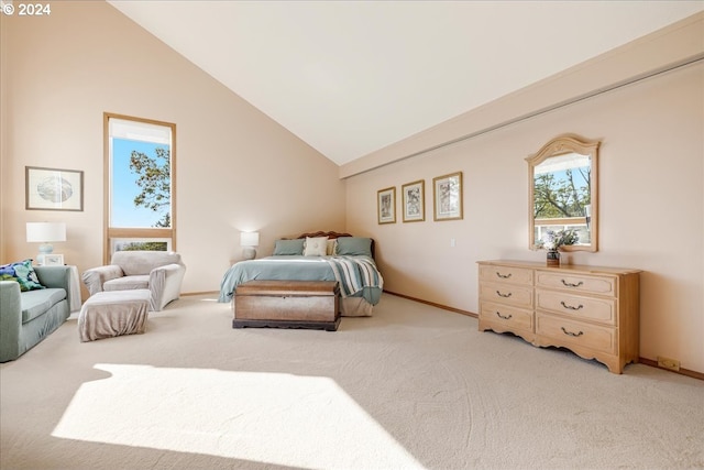 bedroom featuring light carpet and high vaulted ceiling