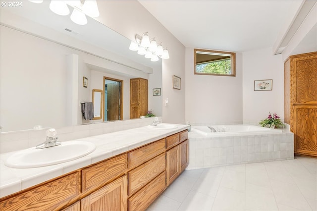 bathroom with vanity, tiled bath, and tile patterned floors