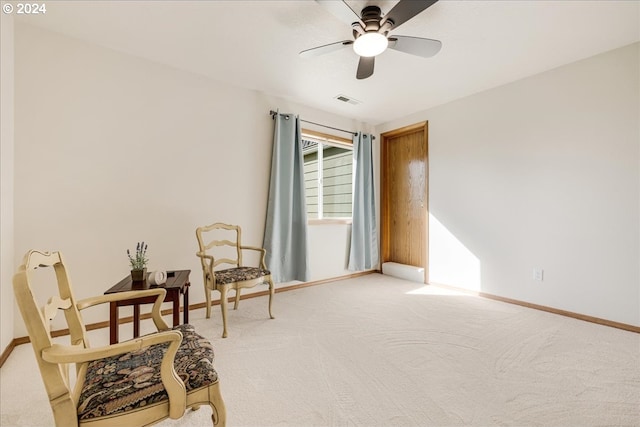 sitting room with carpet and ceiling fan